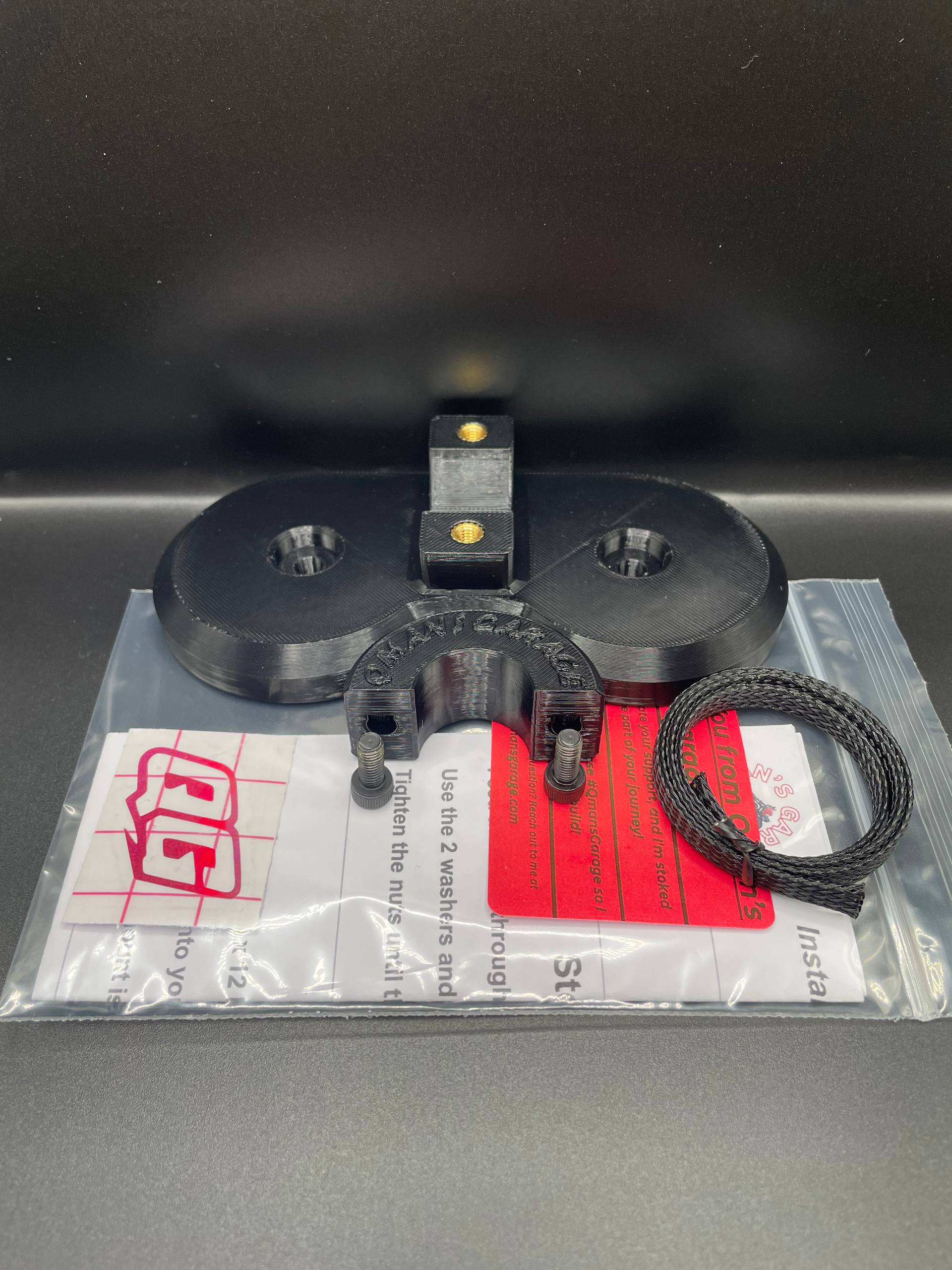 Black mechanical component on a gray surface with a clear plastic bag underneath